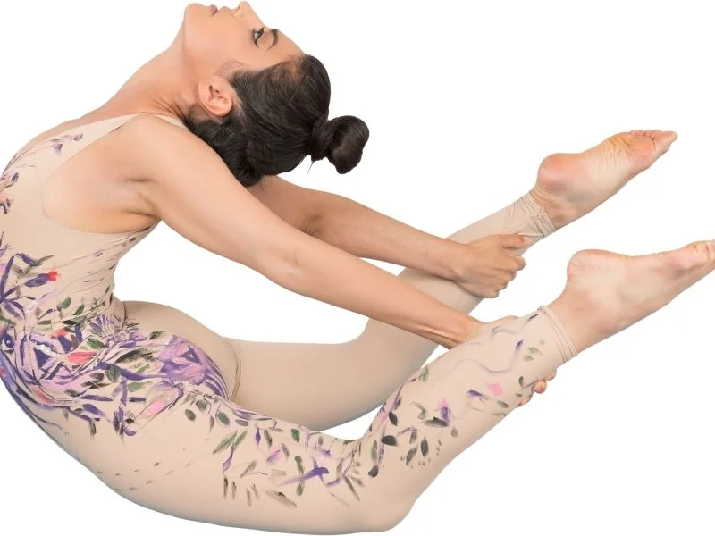 A person doing dynamic stretches like arm circles, leg swings, and torso twists