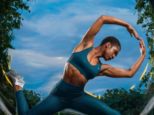 A person doing dynamic stretches like arm circles, leg swings,