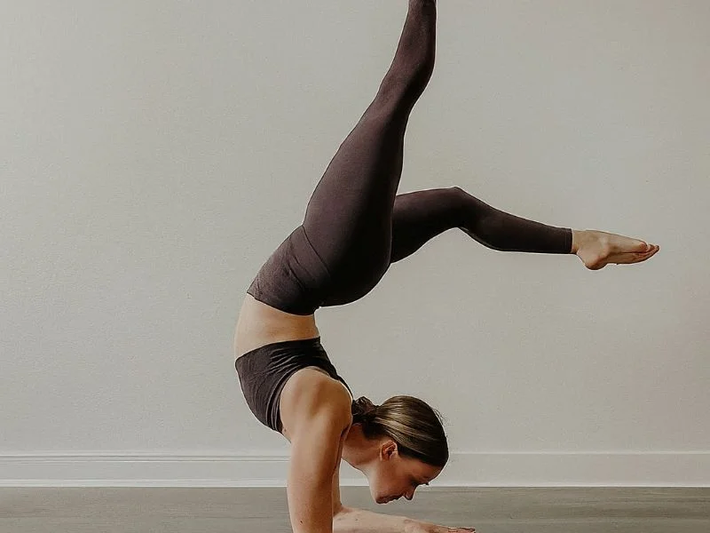 A person practicing yoga or Pilates in a studio or at home