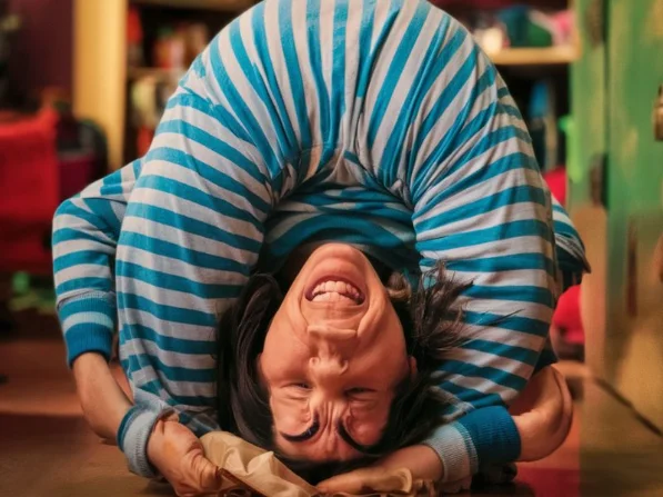 Humorous image of a person struggling to bend over or reach for something