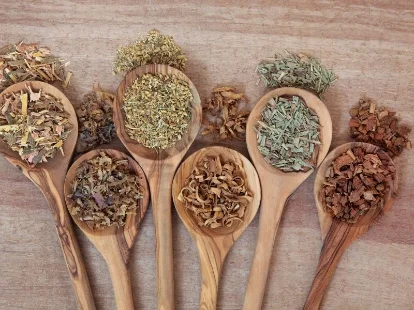A measuring spoon with dried herbs, illustrating the importance of proper dosage