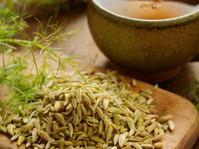 Close-up of fennel seeds and a cup of fennel tea