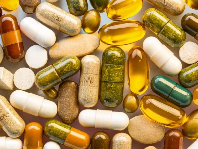 a close-up of various herbal supplement capsules and tablets