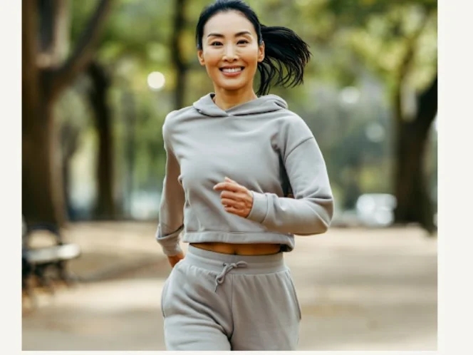 A person smiling and confidently walking outdoors, symbolizing the positive impact of exercise on overall well-being.