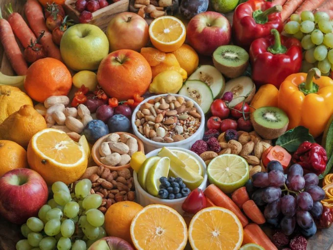 A photo of a colorful array of fruits, vegetables, and other nutrient-rich foods. The foods are arranged in a circle