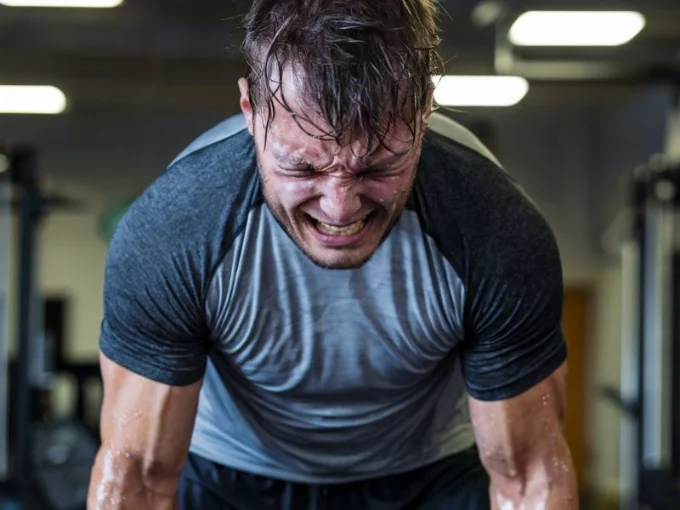 A photo of a frustrated athlete struggling to complete a workout