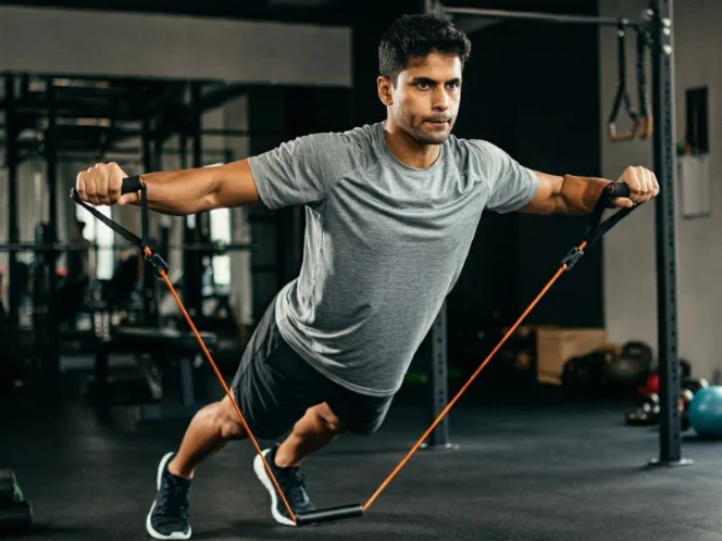 A person performing a resistance band pull-apart