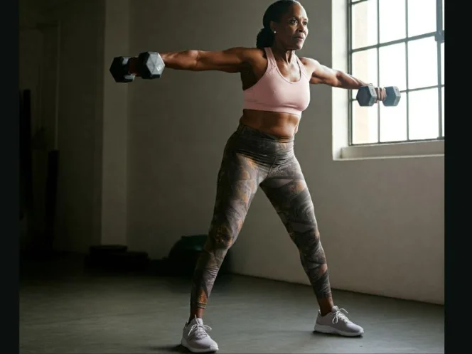 A person performing dumbbell lateral raises