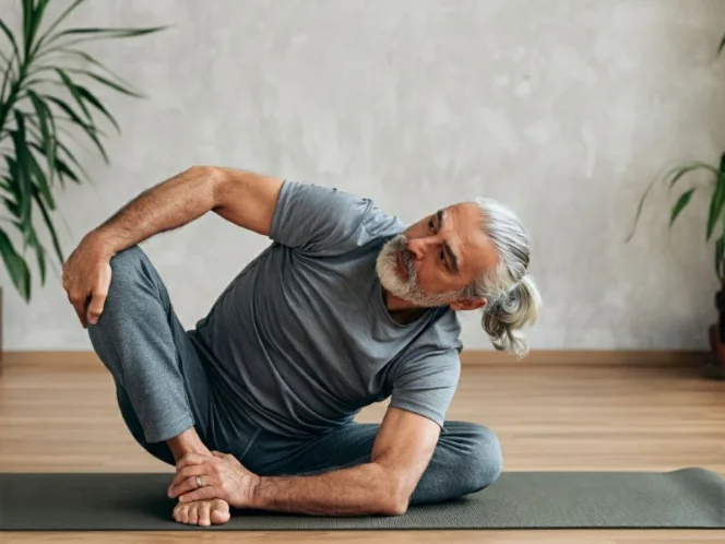 A senior man performing a gentle yoga pose, showcasing the benefits of flexibility and balance exercises