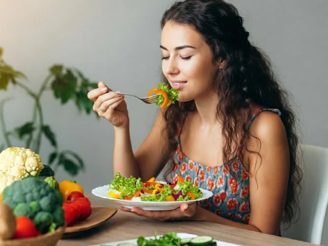 an image of a person enjoying a colorful salad or a balanced meal with a variety of foods from different food groups