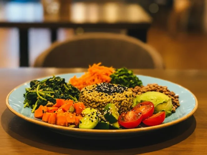 A colorful and appealing plant-based meal with a variety of whole foods, showcasing a balanced plate