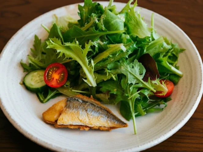 A flexitarian meal with a small portion of fish alongside a large salad