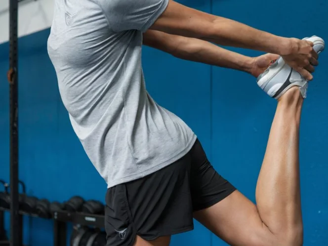 A performing static stretches, holding each stretch for 20-30 seconds