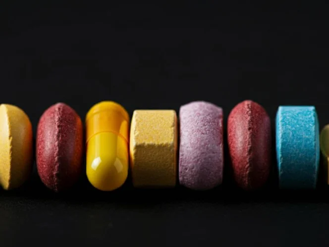 A row of colorful pills, symbolizing the impact of medications on the gut microbiome