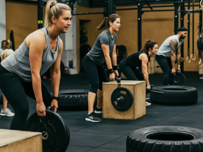 A group participating in a functional fitness class, highlighting the variety of exercises and equipment used